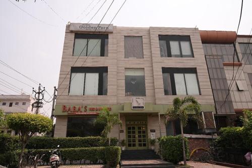 a building with a sign on the front of it at Hotel Golden Fern in Patiāla