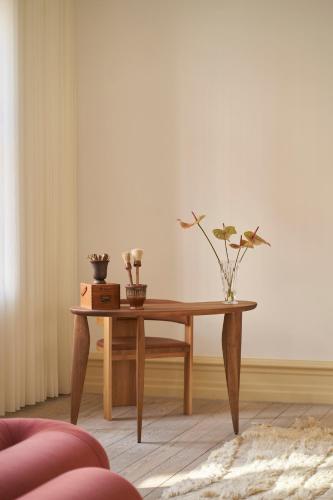 a wooden table with flowers on it in a room at SJ Apartment in Aarhus