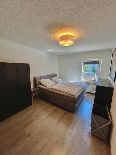 a bedroom with a bed in a room with a window at Ferienwohnung mit Dachterrasse in Selb