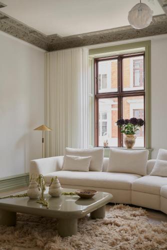 a living room with a white couch and a table at SJ Apartment in Aarhus