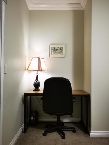 a desk with a chair and a lamp on it at Eagle's House, Room #1 in Victoria