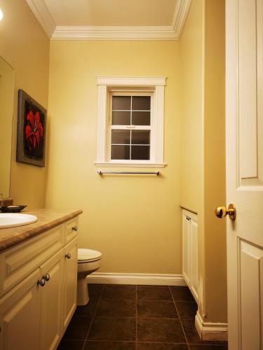 a bathroom with a toilet and a window at Eagle's House, Room #1 in Victoria