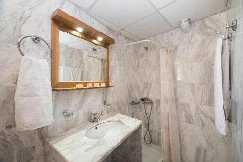a bathroom with a sink, toilet and shower at Mythos Beach Hotel Apartments in Maleme