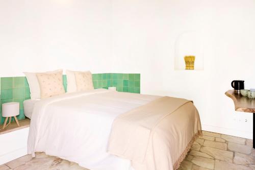 a bedroom with a white bed and a sink at Spot na Serra in Loulé
