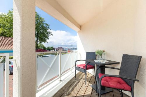 a balcony with a table and chairs on a deck at Haus Panorama Laboe Nr 1 in Laboe