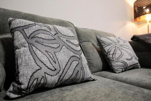 a couch with two pillows on top of it at Bartlam Place, Sleeps 6, Central Oldham - By NMB Property in Oldham