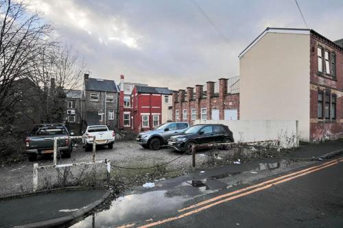 a group of cars parked in a parking lot at Bartlam Place, Sleeps 6, Central Oldham - By NMB Property in Oldham