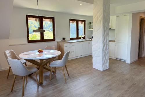a kitchen and dining room with a table and chairs at Cherry Hill Loft in Plitvička Jezera