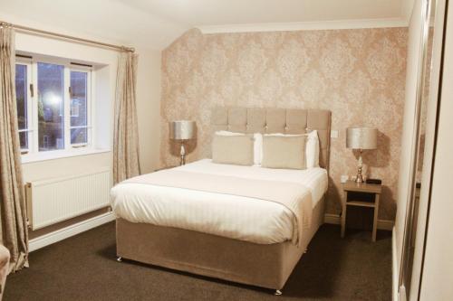 a bedroom with a large bed and a window at Slaters Country Inn in Whitmore