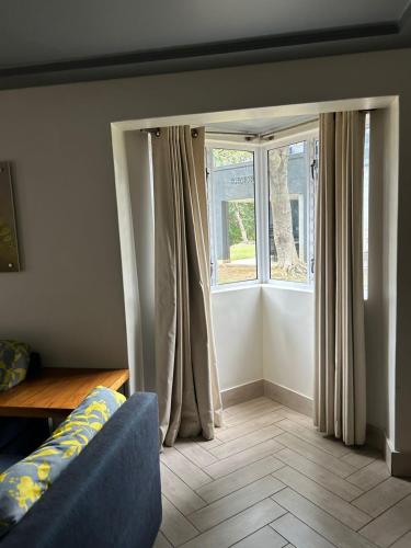 a living room with a couch and a window at Sun Villa in Rustenburg