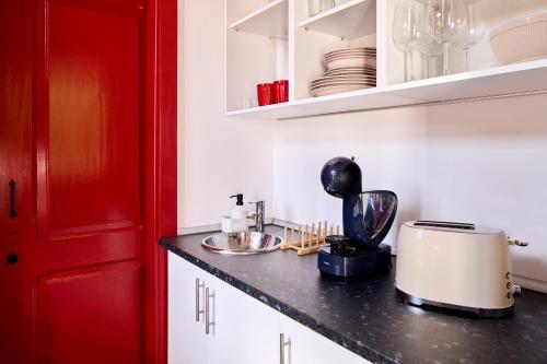 a kitchen with a counter with a toaster on a counter at Spot na Serra in Loulé