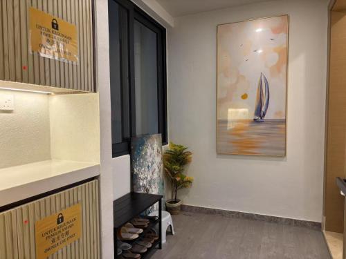 a room with a picture of a sailboat on the wall at TheBess Hotel Tokyo is located adjacent to Singapore and offers a sea viewIt is a family business smart room with the sea view of Princess Bay富力公主湾 in Johor Bahru