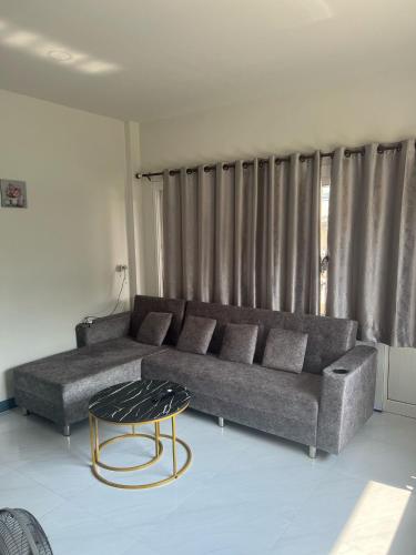 a living room with a couch and a table at Relax home in Ao Nang 