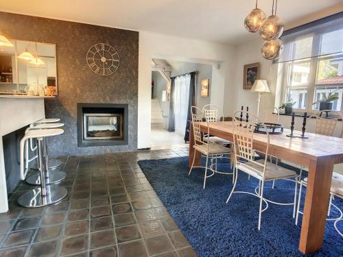a dining room with a table and a fireplace at La Chanterelle in Wavre