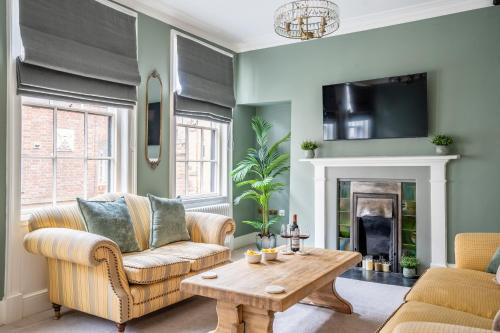 a living room with a couch and a table at Friargate House in York