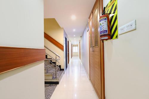 a hallway of a house with a stairwell at FabHotel RKH Skyline Residency in Chennai
