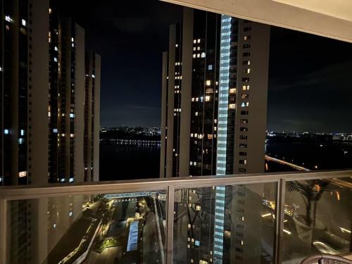a view from the balcony of a building at night at TheBess Hotel Tokyo is located adjacent to Singapore and offers a sea viewIt is a family business smart room with the sea view of Princess Bay富力公主湾 in Johor Bahru