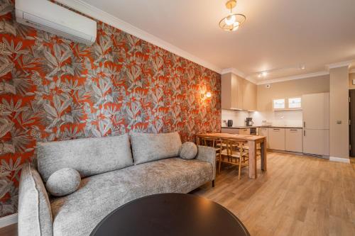 a living room with a couch and a table at RentPlanet - Kępa Mieszczańska in Wrocław