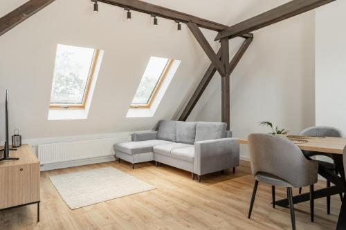 a living room with a couch and a table at Apartamenty SWAN in Gliwice