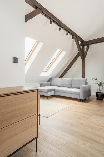 a living room with a couch and a table at Apartamenty SWAN in Gliwice