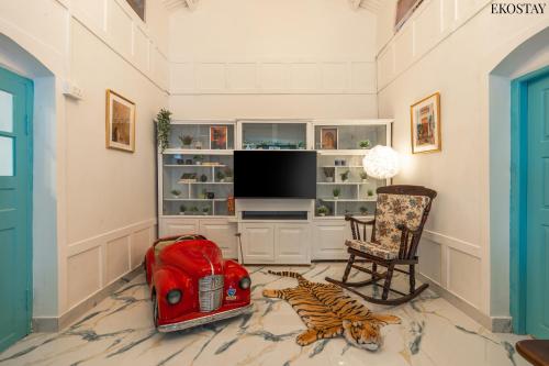 a living room with a television and a tiger laying on the floor at EKOSTAY - Casa Del Sol in Ooty