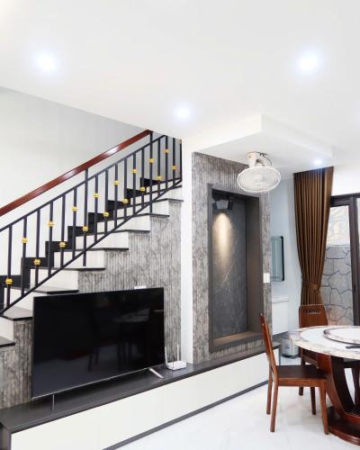 a living room with a tv and a staircase at Subin Homestay Hue in Thôn Kim Long (1)