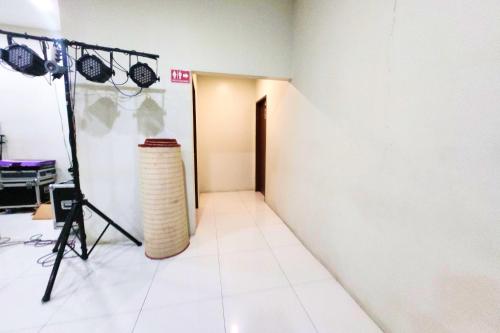 a room with a camera and a tripod and a doorway at DLT Suites Cebu powered by Cocotel in Minglanilla