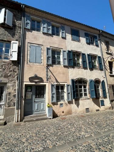 a building with a door and windows on a street at Relais du Noble Voyageur in Brioude