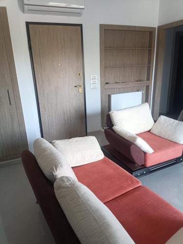 a living room with two beds and a couch at Appartement Costa in El Ahmar