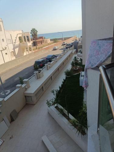 a balcony with a view of a parking lot at Appartement Costa in El Ahmar