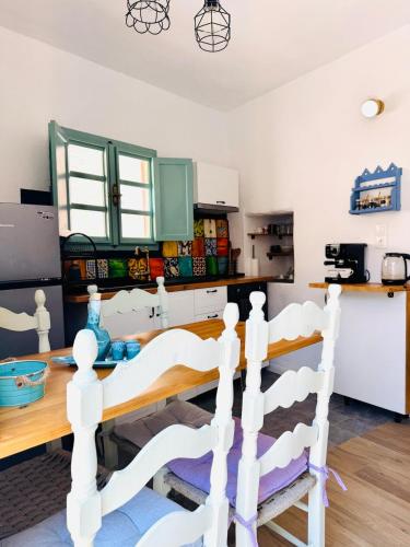 a kitchen with a wooden table and a dining room at Villa Kastrouna, with private heated jacuzzi in Symi