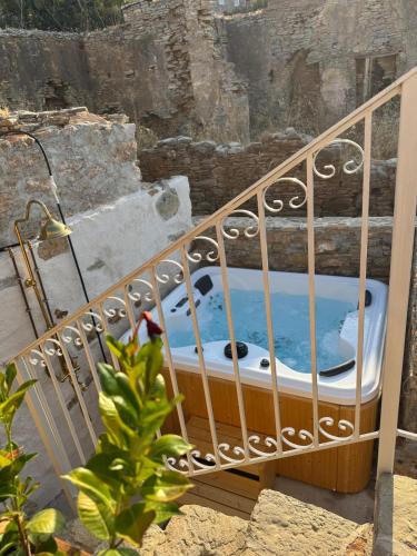 a bath tub sitting on top of a balcony at Villa Kastrouna, with private heated jacuzzi in Symi
