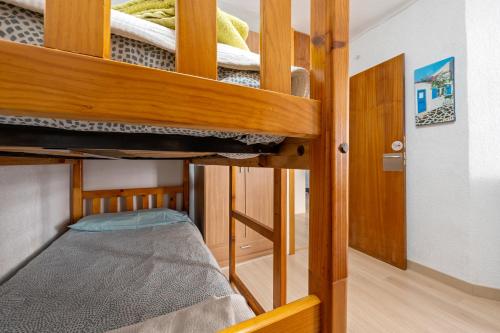 a room with two bunk beds in a room at Tirreno 304 in La Pineda