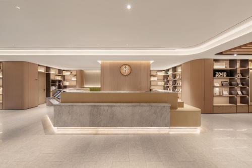a lobby of a store with a clock on the wall at JI Hotel Beijing South Railway Station North Square in Beijing
