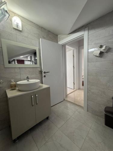 a bathroom with a sink and a mirror at Ares Vilları in Antalya