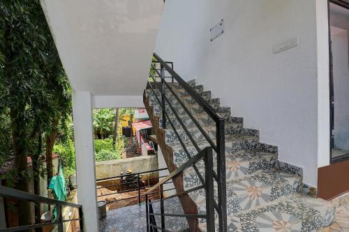 a staircase in a house with a tile floor at FabHotel Zelosena in Vagator