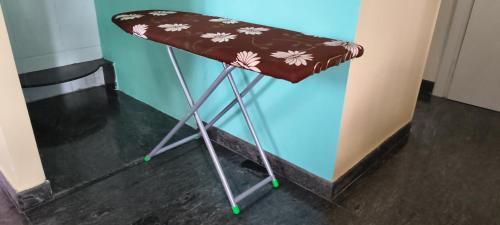 a brown bar stool with flowers on it at Single Bedroom Full independent house walkable distance to Dasarahalli Metro in Bengaluru