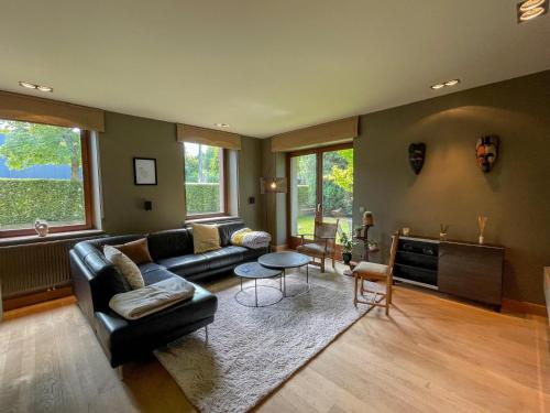 a living room with a couch and a table at Le Manoir W in Waimes