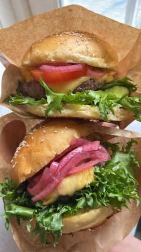 a group of three hamburgers with lettuce and tomatoes at Nygård Camping in Hjelle