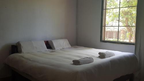 a bedroom with a bed with two towels on it at Danoopa homestay in Savannakhet