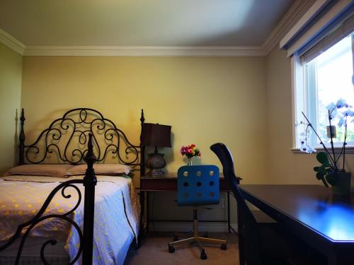 a bedroom with a bed and a desk and a chair at Eagle's House, Room #2 in Victoria