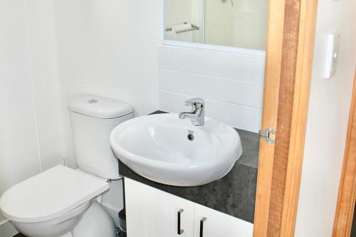 a bathroom with a white toilet and a sink at BIG4 Rutherglen Holiday Park in Rutherglen