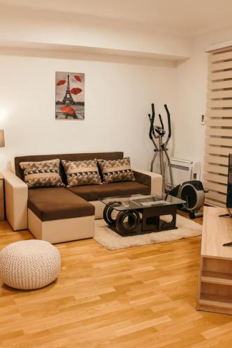 a living room with a couch and a table at Fit Mornings Apartment in Skopje