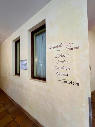 a wall with writing on the side of a building at Hotel Landhaus Milser in Duisburg