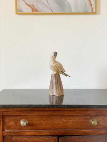 a small bird sitting on top of a dresser at Le Manoir W in Waimes