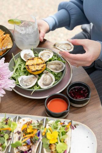 a table with a plate of oysters and salad at Halifax Marriott Harbourfront Hotel in Halifax