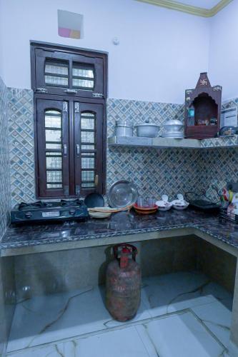 a kitchen with a counter top with pots and pans at Prakriti Awas Homestay in Jāmb