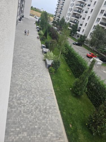 a walkway with benches and plants on the side of a building at Pipera Platza Residence 5 luxury 1 bedroom in Voluntari