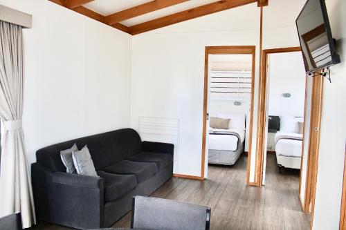 a living room with a couch and a bedroom at BIG4 Rutherglen Holiday Park in Rutherglen