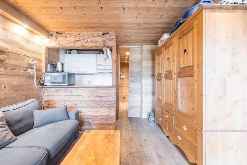 a living room with a couch and a kitchen at APT centre station vue sur les pistes de Val Thorens 6p in Val Thorens